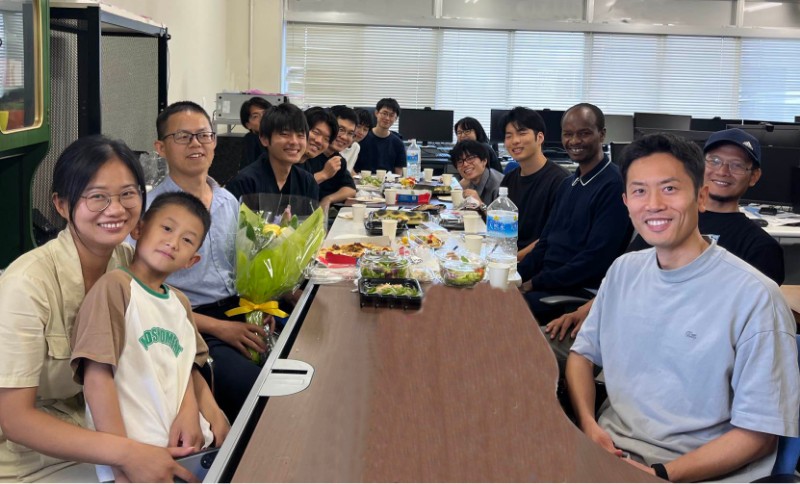 A farewell party with lab members along with a visiting professor and his family